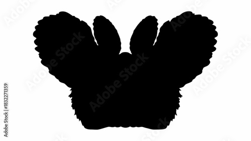 Silhouette of a fluffy animal with large ears and fur in a dark contrast against white background view