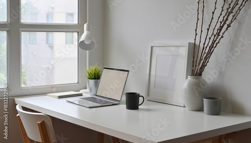 Minimalist Workspace with natural light: The elegant workspace, illuminated by soft natural light, features a laptop, enhancing productivity, alongside tasteful decor.