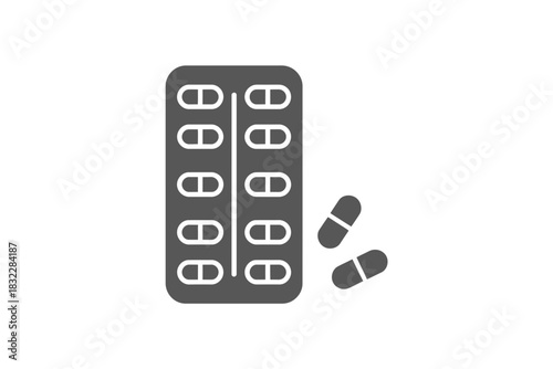 A blister pack of capsules with two capsules outside the packaging near it