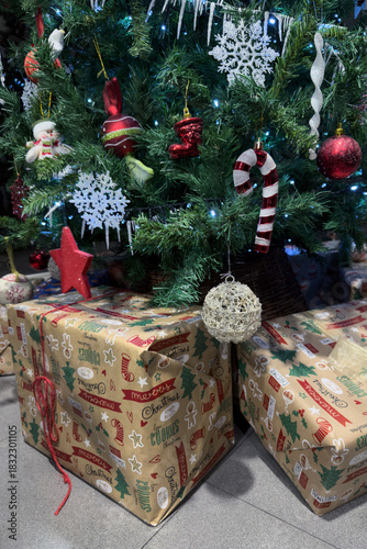 green christmas tree decorated with christmas decorations and gift boxes