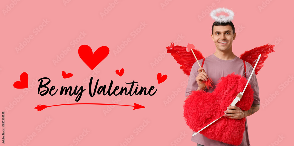 Obraz premium Young man dressed as Cupid with bow and heart pillow on pink background. Valentine's Day celebration