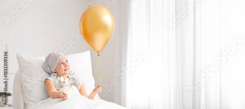 Little girl with golden bal...