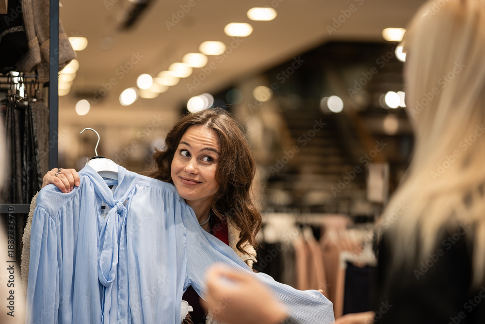 Ταπετσαρία Woman making funny face deciding on buying blouse