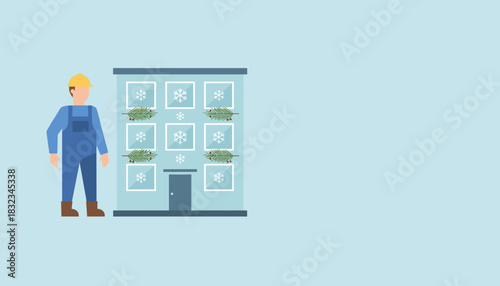 Maintenance worker standing by a building decorated for the winter holidays