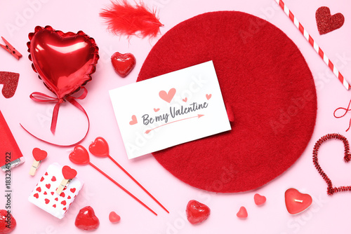 Composition with greeting card, stylish beret and different decor for Valentine's Day celebration on pink background