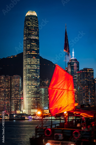 Canvas Print Awesome nighttime view of a brightly illuminated junk boat in Victoria Harbor in