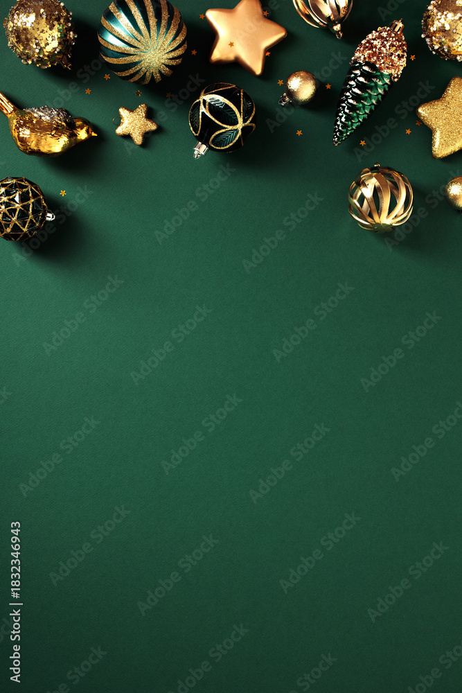 Naklejka premium Luxury Christmas vertical background with gold and green ornaments, baubles, stars, pine cones on dark green table. Art deco style poster design.