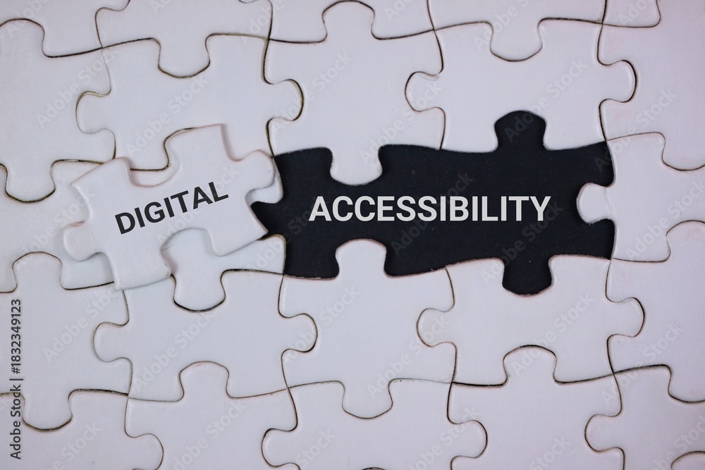 Fototapeta premium A close-up of interlocking puzzle pieces highlighting digital accessibility. The black piece labeled ACCESSIBILITY and a white piece labeled DIGITAL, symbolizing inclusive technology and design.