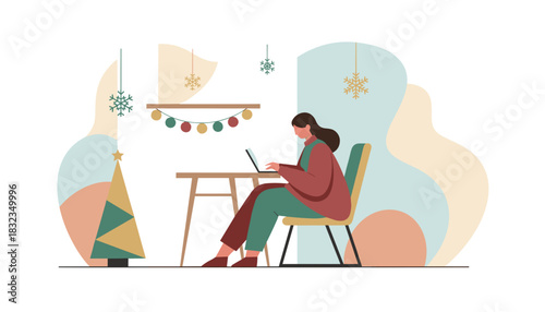 Woman working on laptop at desk in a cozy home office decorated for Christmas and winter holidays