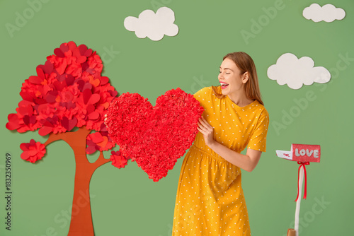 Young woman with heart near...