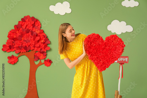 Young woman with heart near...