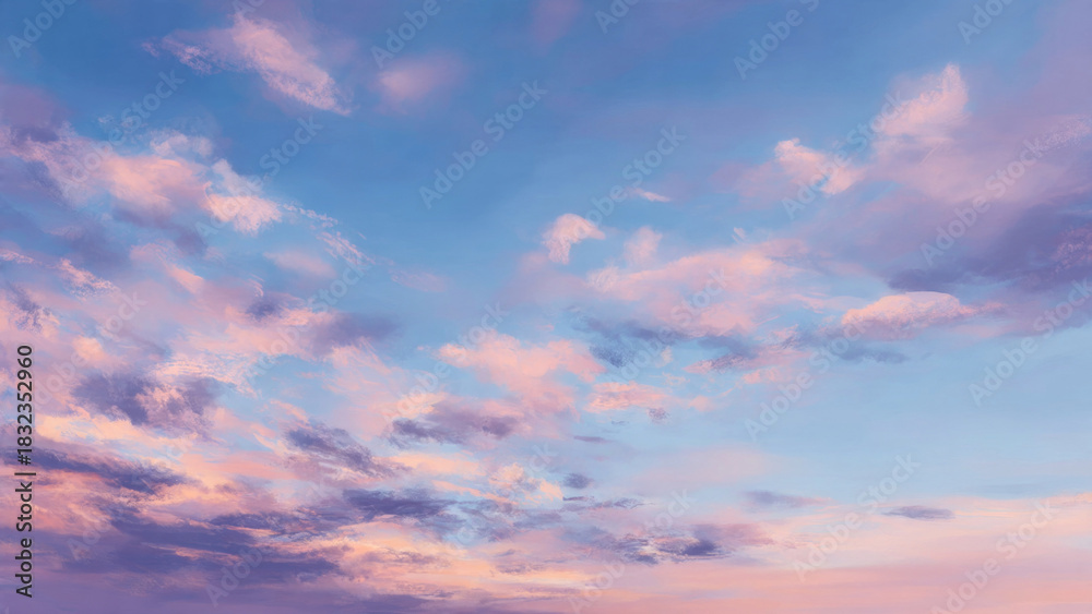 Fototapeta premium Pastel clouds drift across a serene sky, transitioning from soft blue to gentle pink and warm purple. Beautiful, tranquil, dreamy atmosphere.