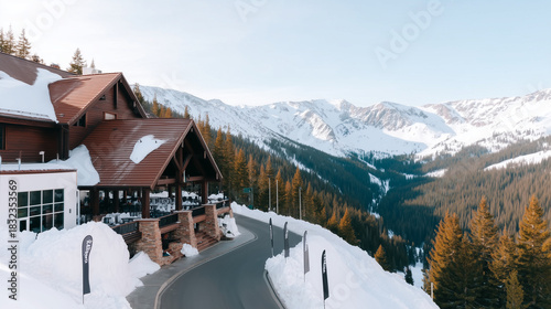 A luxury ski resort lodge on a snowy mountainside. Alpine hotel with a scenic view of a winter mountain range. Travel and vacation destination