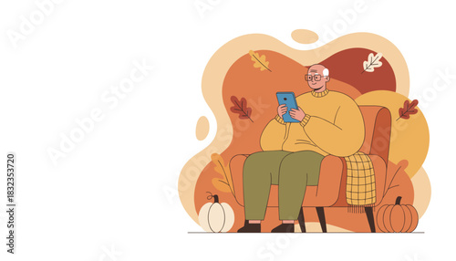 Senior man using tablet comfortably in an armchair during autumn Leisure technology relaxation