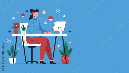 Woman working remotely at a desk with computer and plants decorated for the winter holiday season