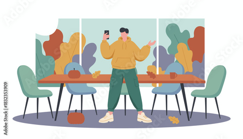 Casual man holding a phone standing in a room with fall decoration and colorful plants