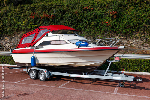 Fototapeta Naklejka Na Ścianę i Meble -  Image of a  small boat yacht on a trailer near Como Lake, Italy, Europe
