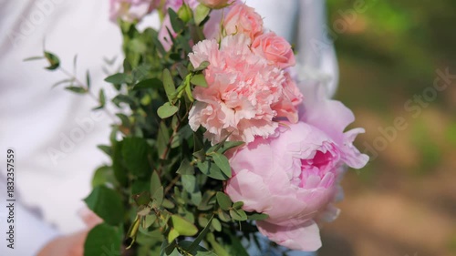 bouquet of flowers in close-up in hands of groom