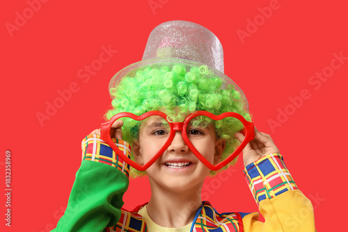 Happy young boy in clown co...