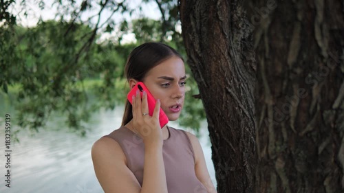 young woman talking on the phone unhappy. outdoors