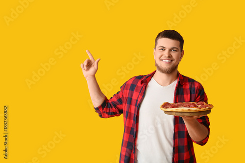 Young man with tasty pepper...