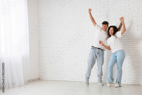 Young happy couple celebrat...