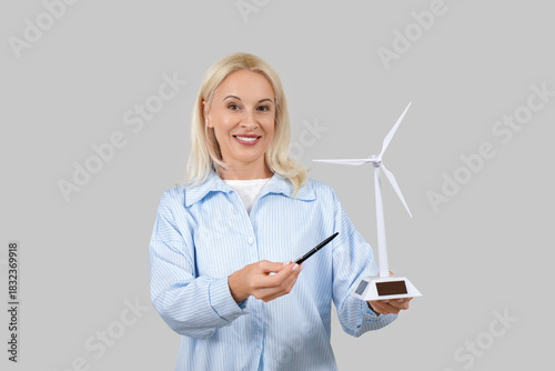 Mature woman with wind turb...