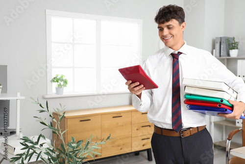 Male accountant using calcu...