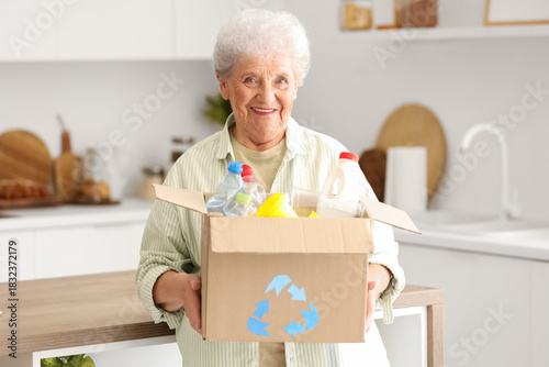 Senior woman with box of ga...
