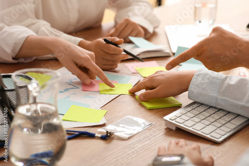 Business team with many sticky notes during meeting in office, closeup