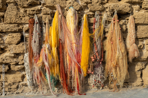 A display of colorful  fishnets against a wall