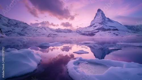 The Matterhorn mountain reflected in a frozen alpine lake at a purple winter sunrise. Iconic snow-covered peak in the Swiss Alps near Zermatt