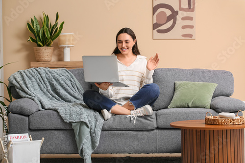 Young woman with laptop vid...