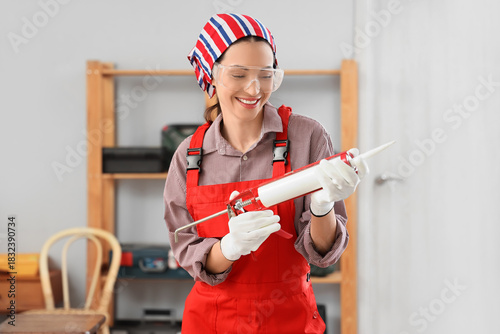 Female worker with sealant ...