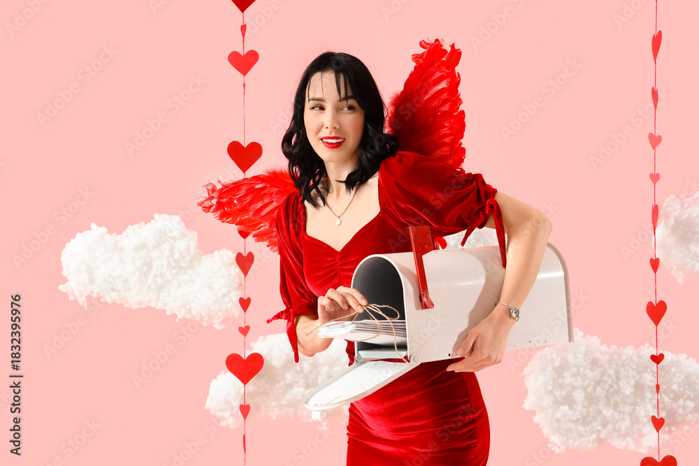 Obraz premium Beautiful young happy woman dressed as cupid with mailbox of love letters in clouds on pink background. Valentine's Day celebration