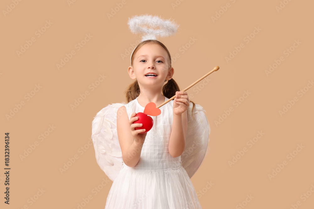 Fototapeta premium Cute little girl dressed as Cupid with arrow and heart on brown background. Valentine's Day celebration
