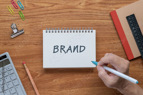 There is notebook with the word BRAND. It is as an eye-catching image.
