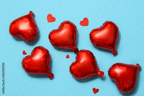 Air balloons in shape of heart on blue background. Valentine's day celebration