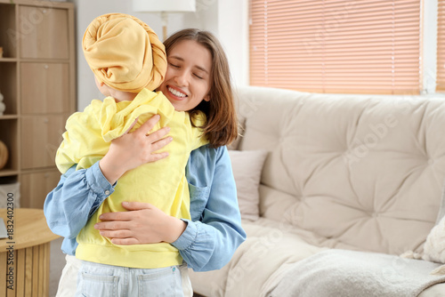 Mother hugging her little d...