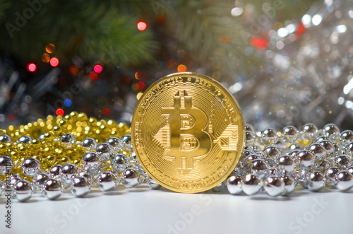 Bitcoin Coin with Gold and Silver Beads on Festive Pine and Holiday Lights Background