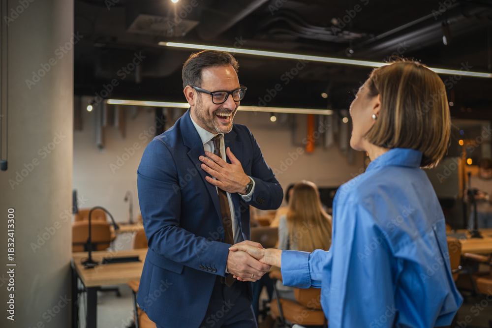 Naklejka premium Smiling business colleagues enjoying a casual conversation in the office