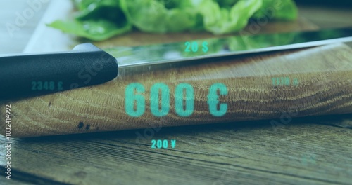 Showing curved wooden cutting board holding chef knife on table, with teal overlays and lettuce