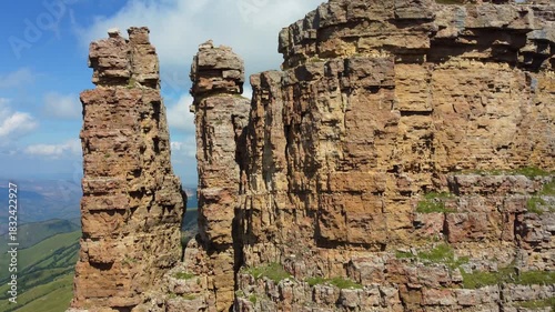 Rocks of two monks, Bermamyt plateau, Karachay-Cherkess Republic. The top of the cliff. Incredible natural epic landscape of the Caucasus, Elbrus region. 4K. dron