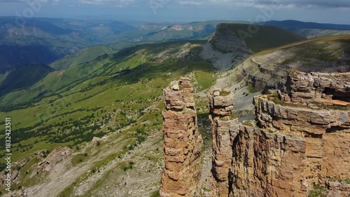 Rocks of two monks, Bermamyt plateau, Karachay-Cherkess Republic. The top of the cliff. Incredible natural epic landscape of the Caucasus, Elbrus region. 4K. dron