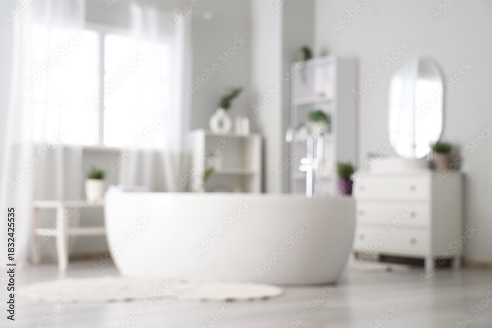 Fototapeta premium Blurred view of interior of modern white bathroom with pots of lavender flowers