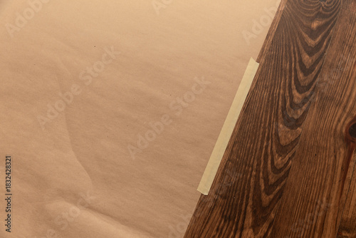 Brown paper taped to wooden floor