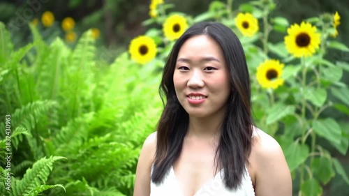 Woman posing with sunflowers in a garden