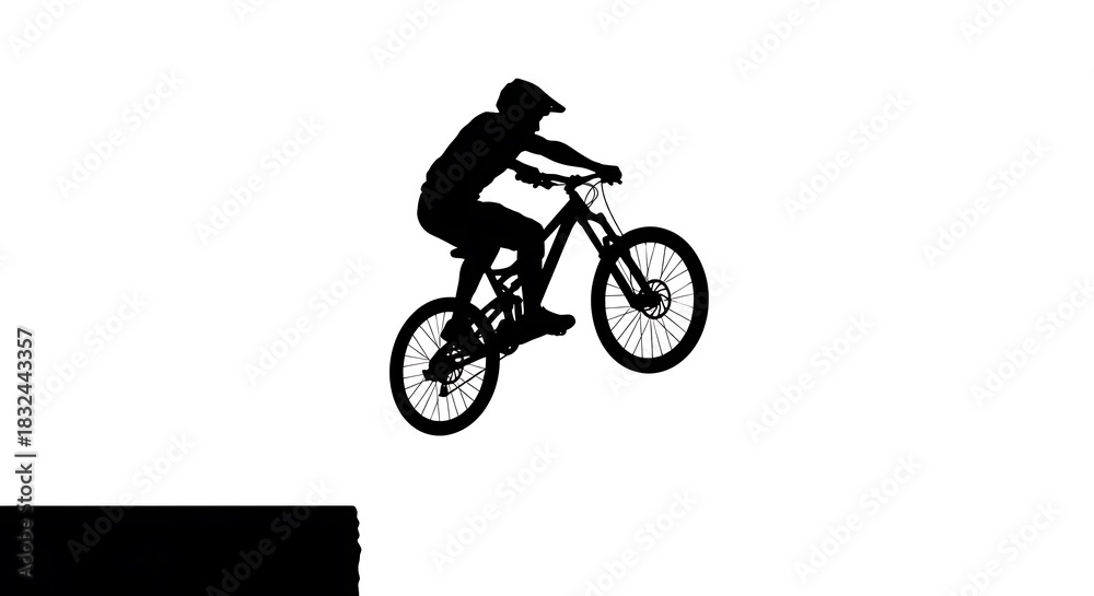 Fototapeta premium Silhouette of a mountain biker performing a jump against a white background.