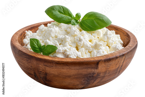 White cottage cheese with green basil leaves in a wooden bowl dairy food