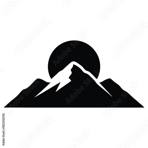 Striking mountain silhouette with sun rising behind the majestic peaks